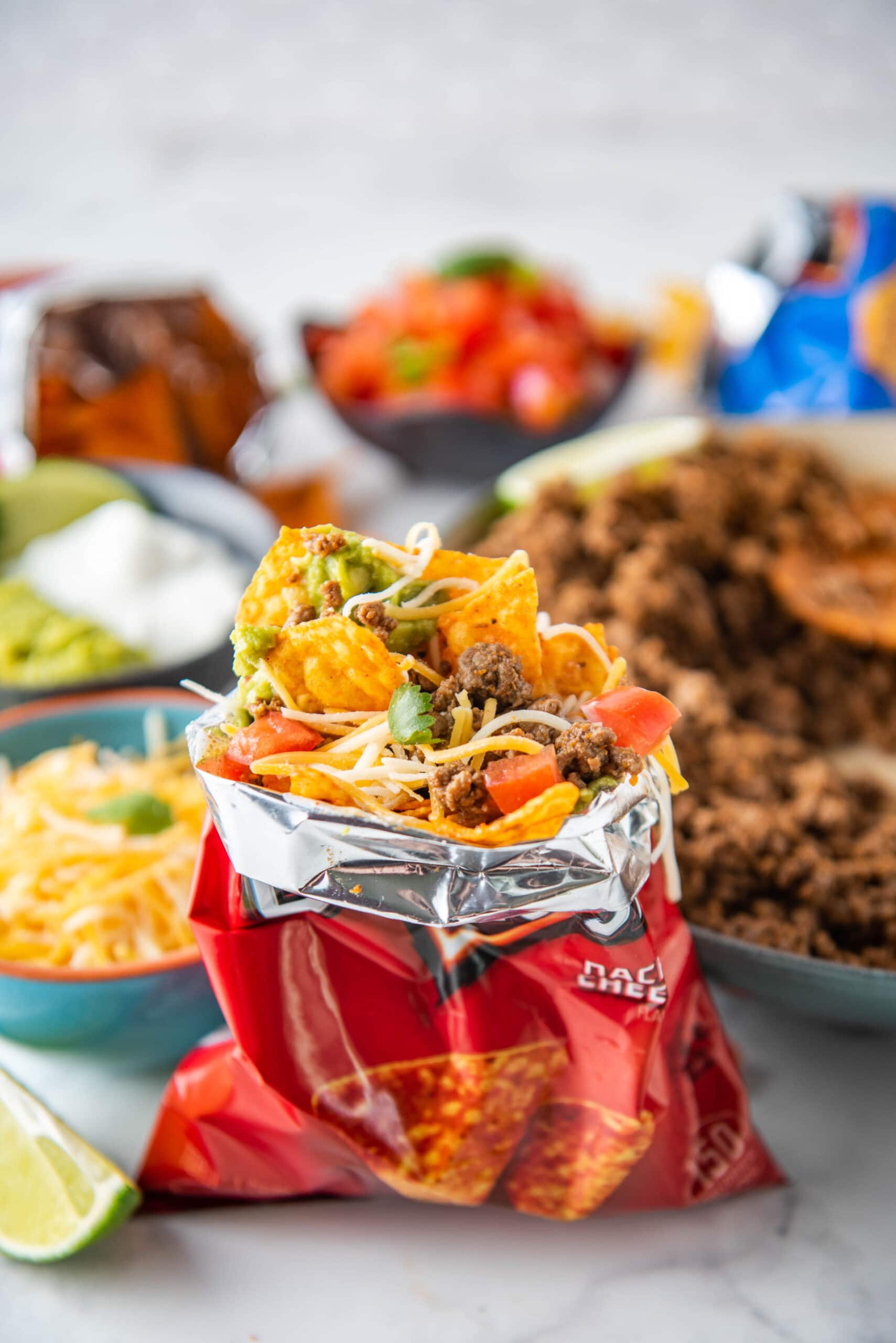 An open Dorito bag contains all the ingredients for walking tacos