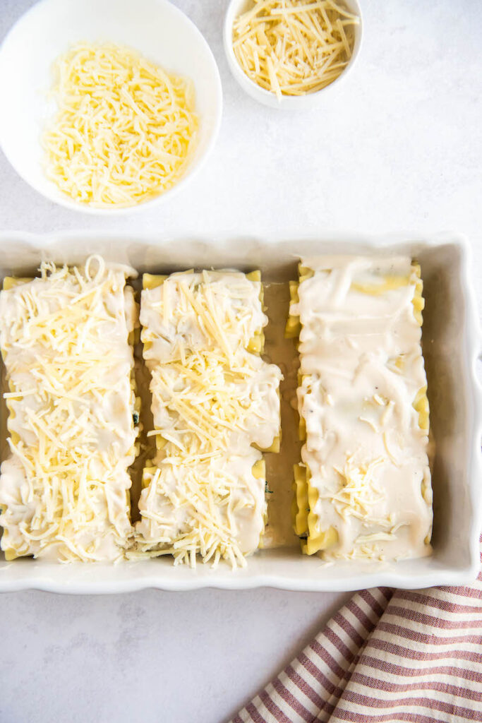 White Chicken Lasagna Rollups are in a casserole dish