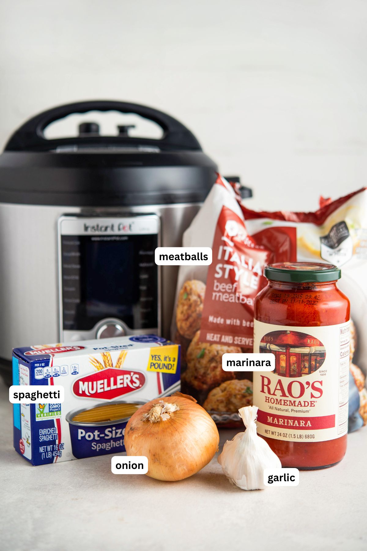 Instant pot spaghetti and meatballs recipe in order from top to bottom: meatballs, marinara, spaghetti, onion, garlic.