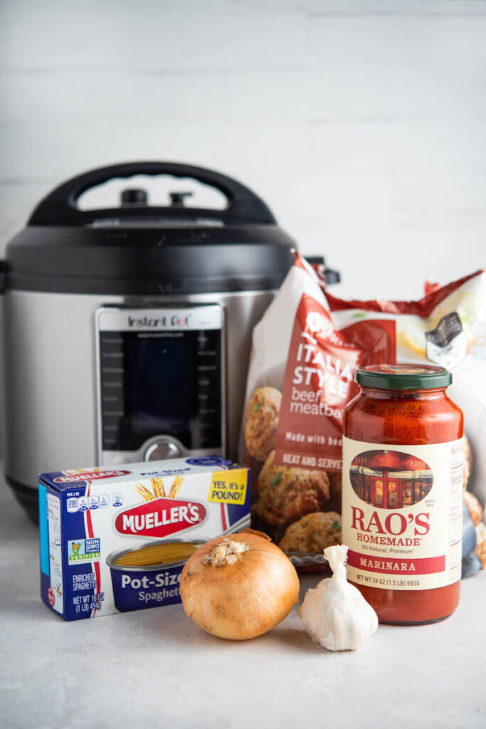 Ingredients for spaghetti with an instant pot in the background.