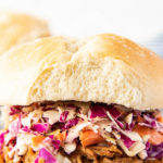 Pinterest logo image of pulled pork sandwich with writing on the photo.