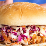 Close up image of pork sandwich for pinterest with wording on the top.