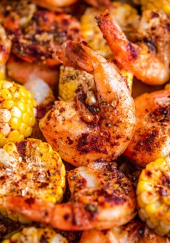Cooked shrimp and corn on a roasting pan.