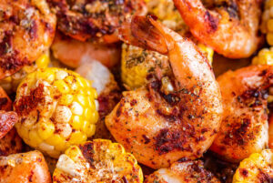 Close up of garlic butter shrimp and corn.