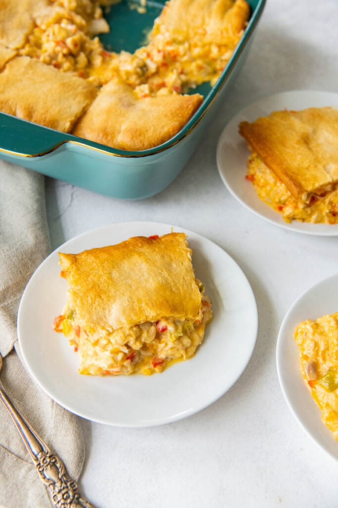 A few serving of Cajun Chicken casserole are placed on white plates