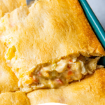 Overhead view of cajun chicken casserole on a spatula with wording on bottom for Pinterest.