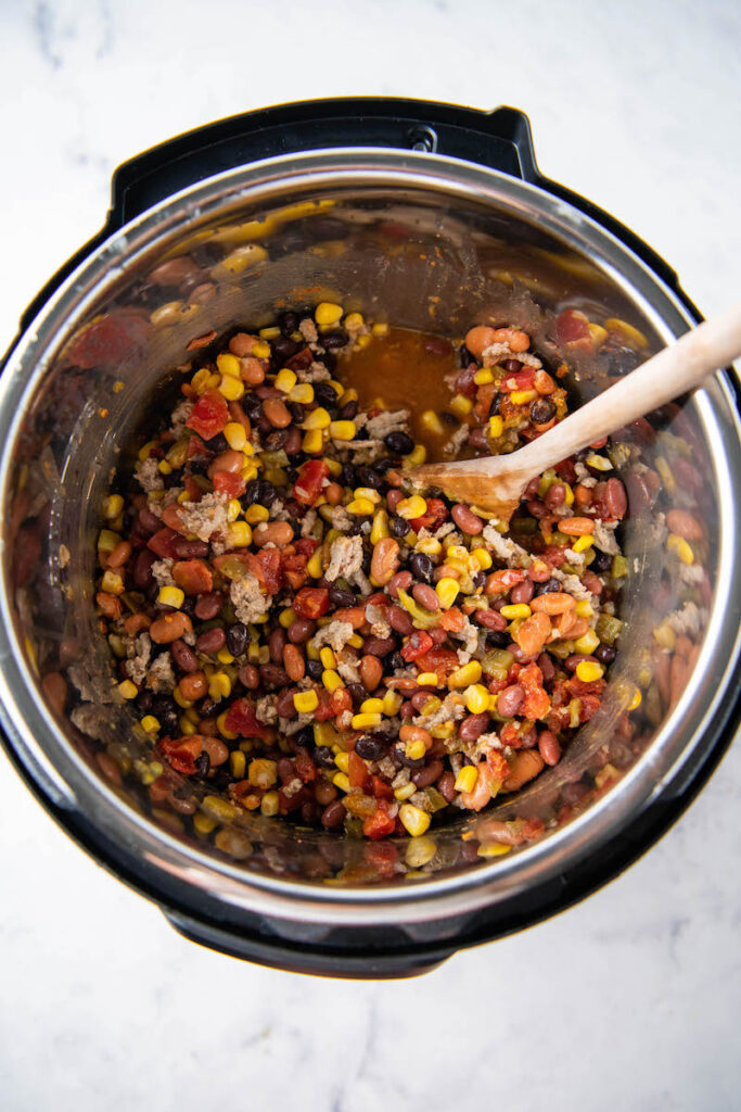 The ingredients for taco soup are all mixed together in the instant pot