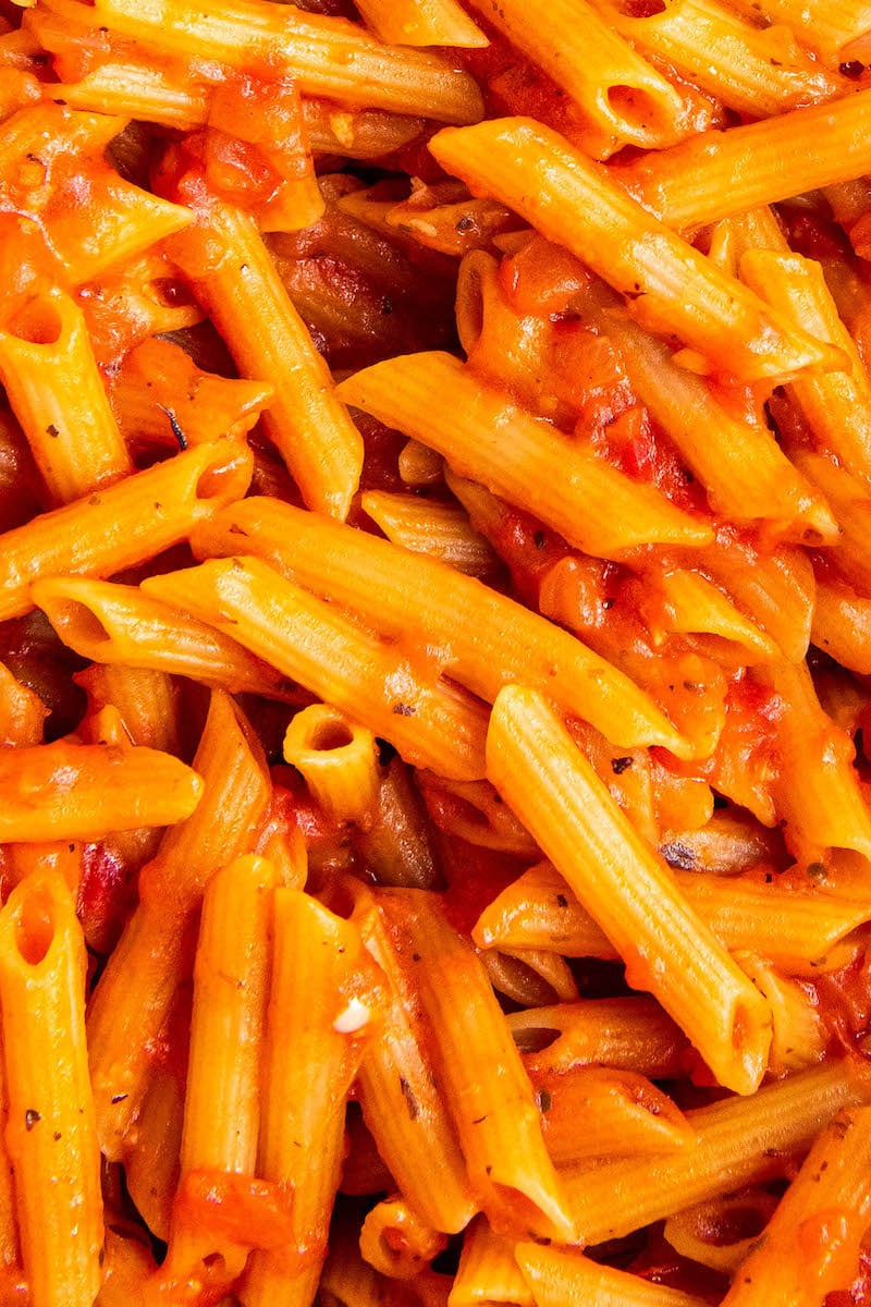 Pasta noodles are covered in delicious red sauce