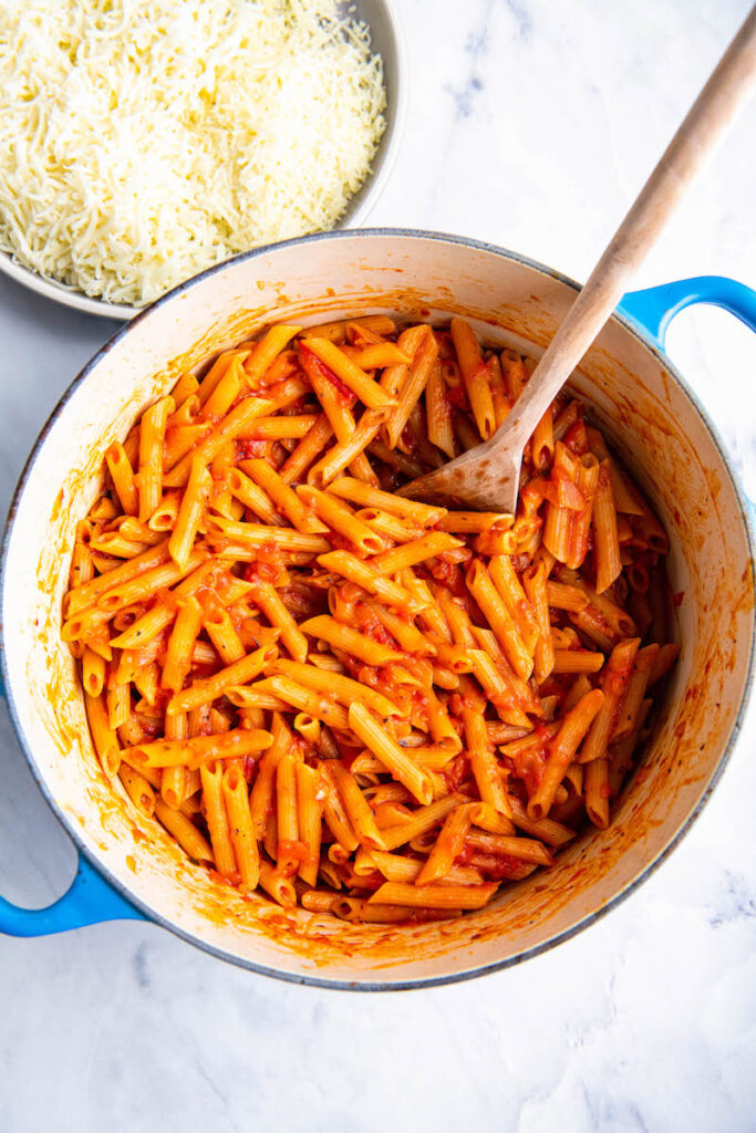 Penne noodles are stirred into the red sauce