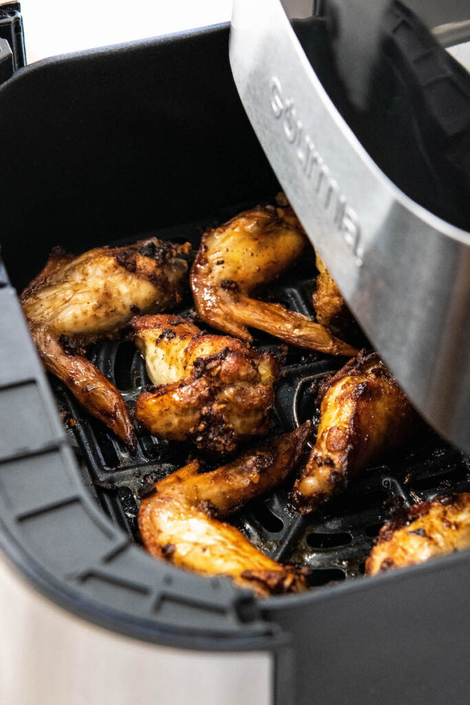 A close up shot shows the chicken is fully cooked in the air fryer.