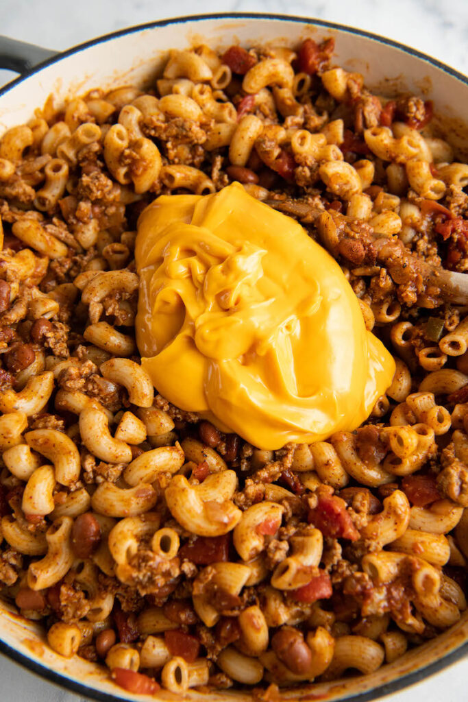 Yellow Velveeta cheese is placed on top of the mixture.