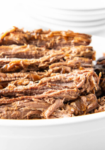Shredded beef is in a white serving bowl.