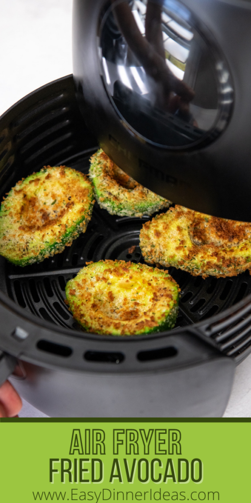 Air Fried Avocados are sitting in a basket of an air fryer.