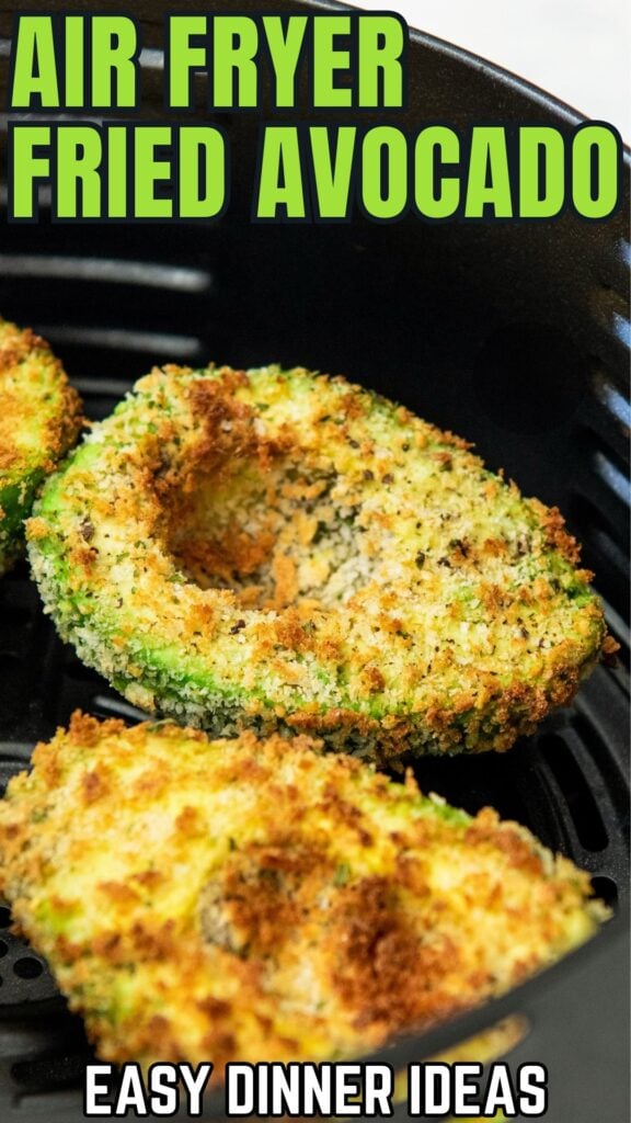 Golden brown air fryer avocados are in the basket of an air fryer.