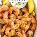 Air fryer shrimp are presented in a white serving bowl and are ready to eat.