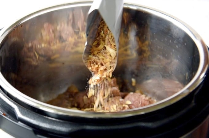 Onion Soup packet being added to an instant pot.