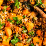 A close up image shows the ingredients for lentil stew are fully cooked.