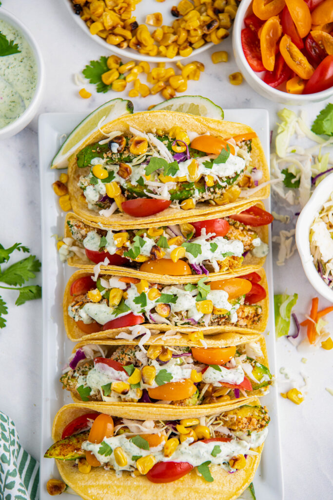 Air fried avocado tacos on a white plate