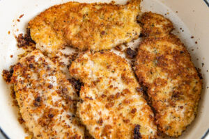 Browning chicken breasts in a pan.