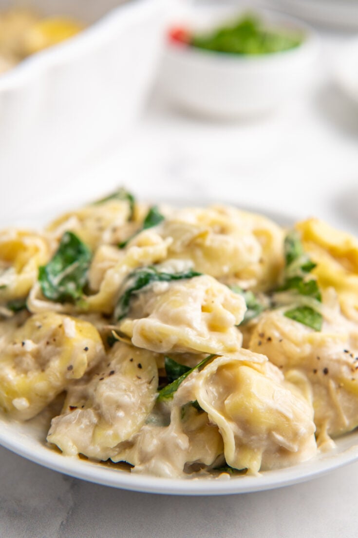 Baked tortellini on a white plate.