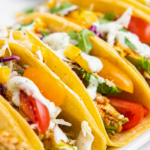 Tacos stuffed with air fried avocado slices and tomatoes