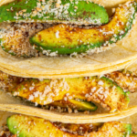 Overhead image of fried avocados in tortillas.