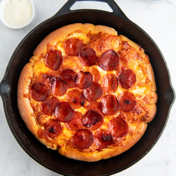 A pepperoni pizza cooked in a cast iron skillet