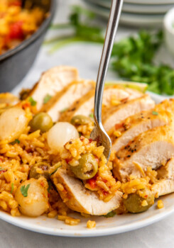 A plate filled with Spanish rice and chicken