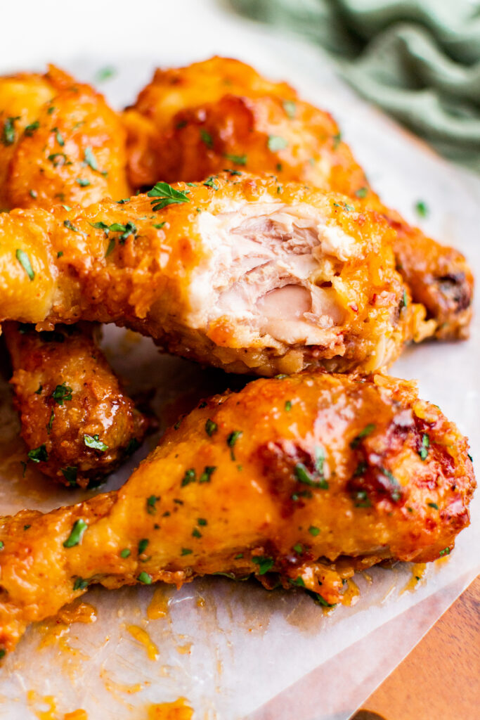 A piece of chicken has been bitten into, revealing the white meat center.