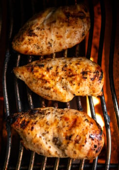 3 Large chicken breast on a gas grill cooking