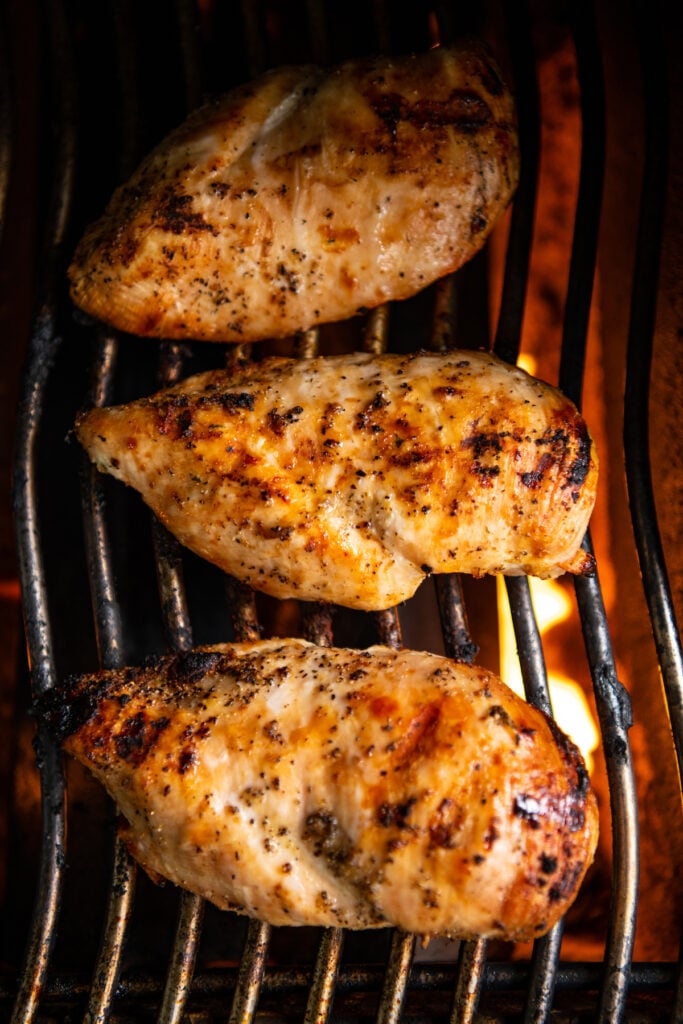 3 Large chicken breast on a gas grill cooking