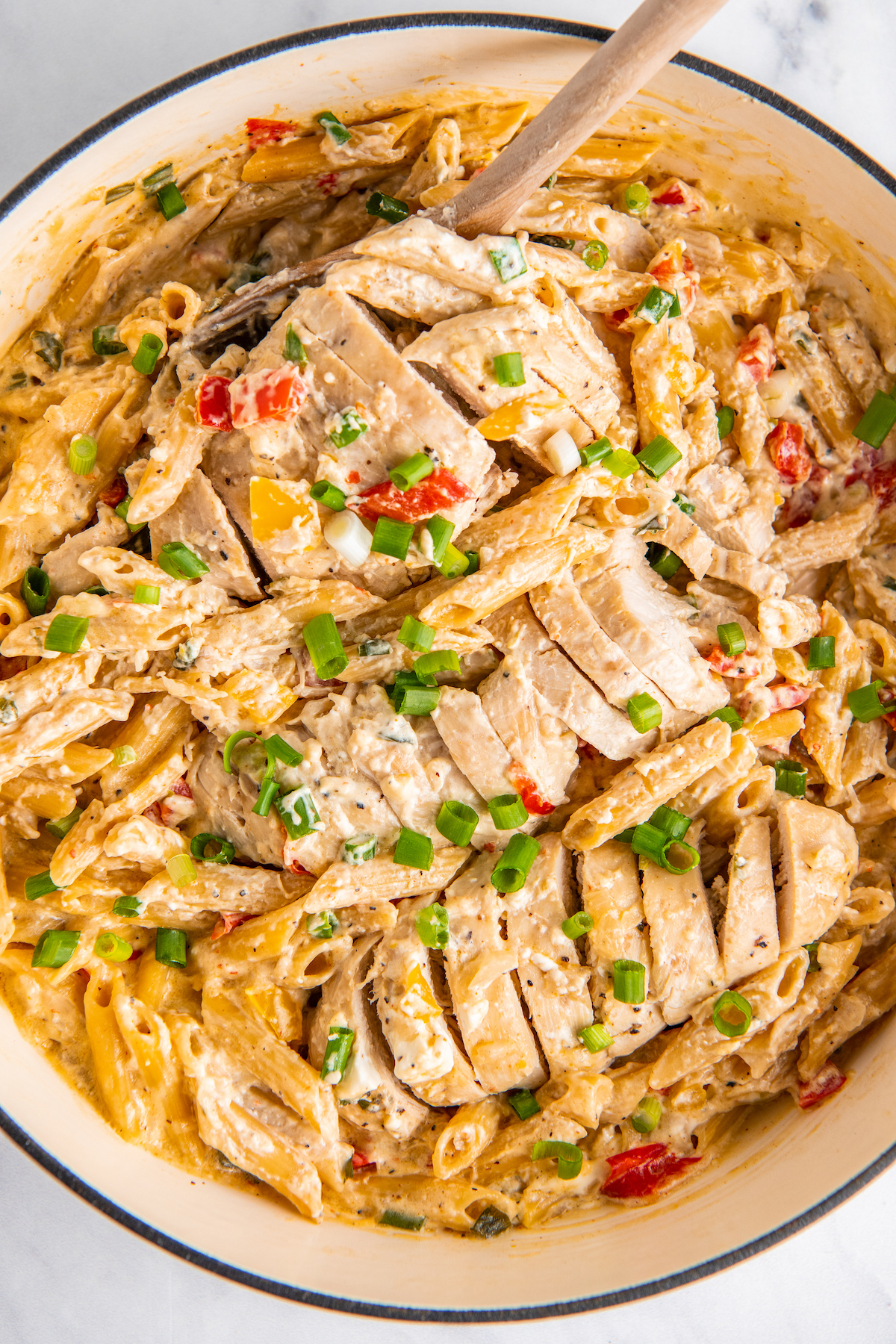 Chicken and pasta are in a pot, fully cooked and ready to eat. 