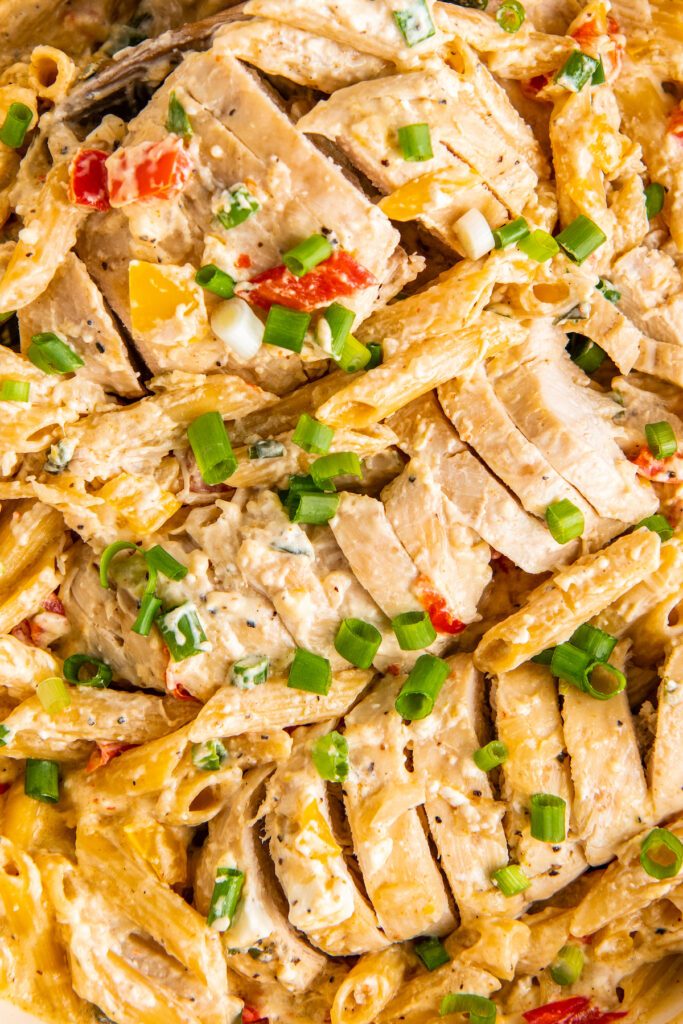 Chicken and pasta are garnished with fresh parsley.