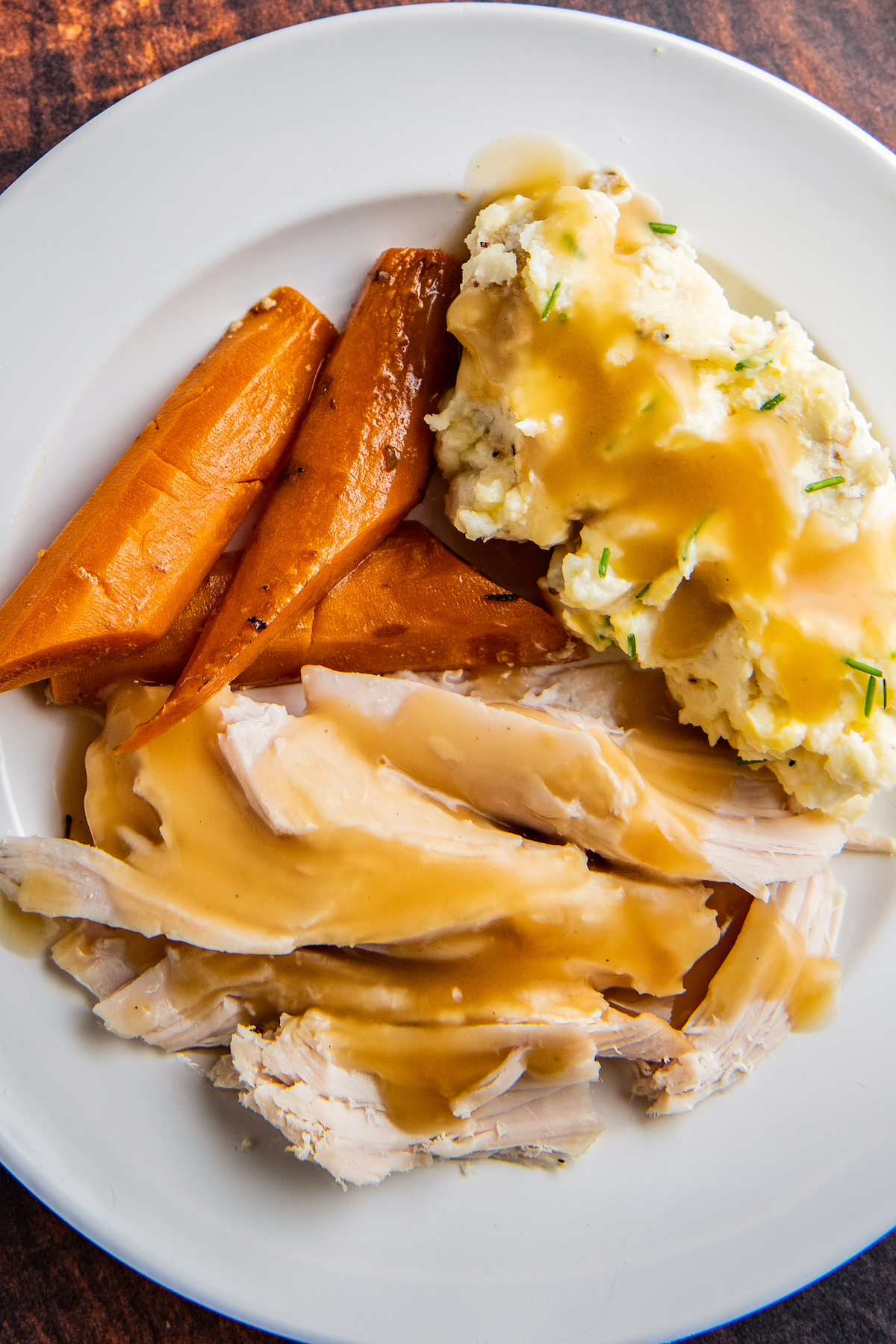 turkey, carrots, and mashed potatoes on a plate 