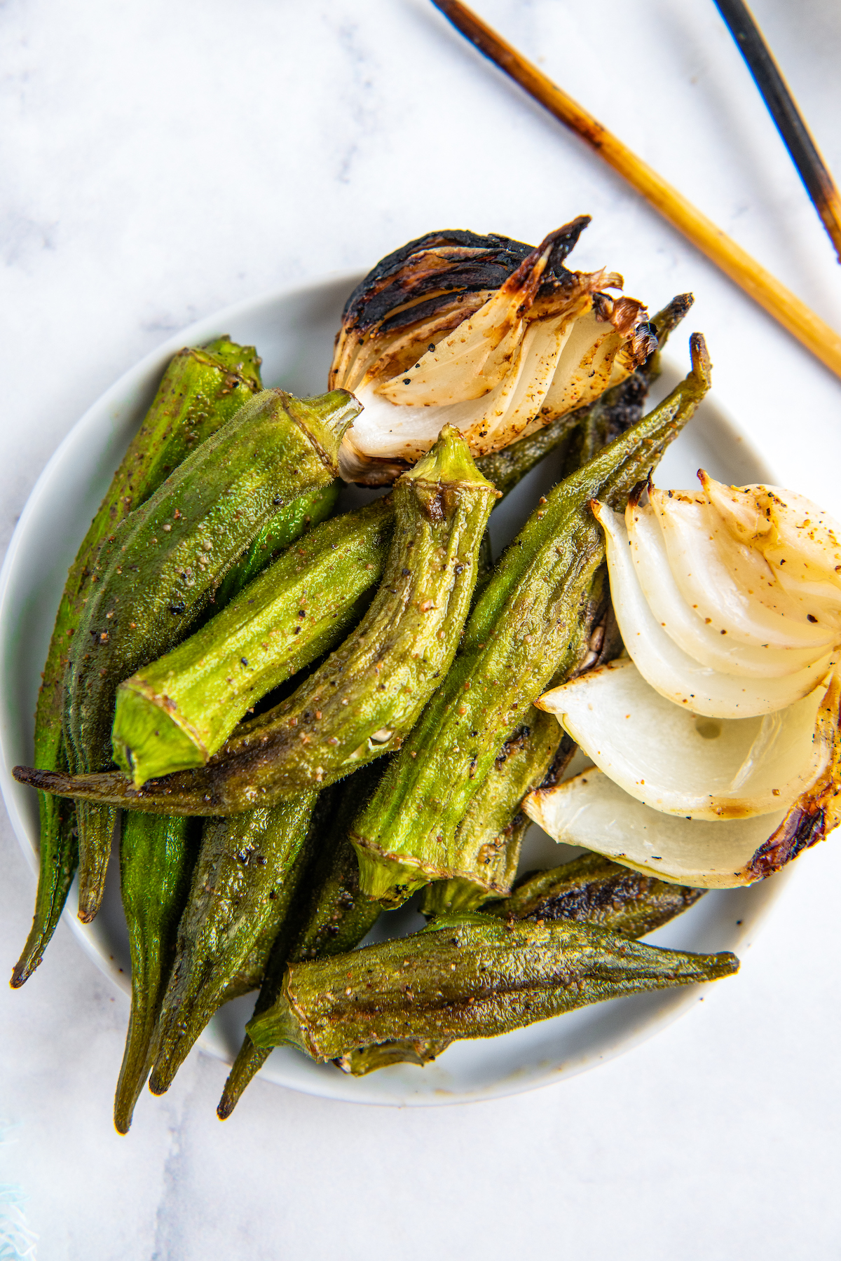 grilled okra and onion on a plate off the skewer and ready to eat 