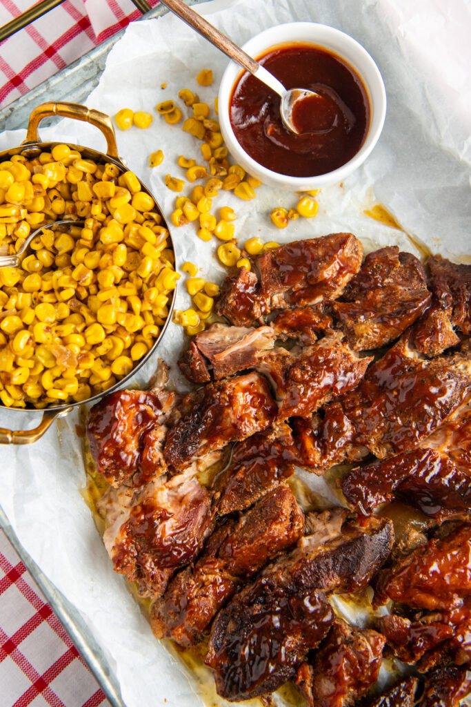 dish of BBQ ribs with corn and sauce
