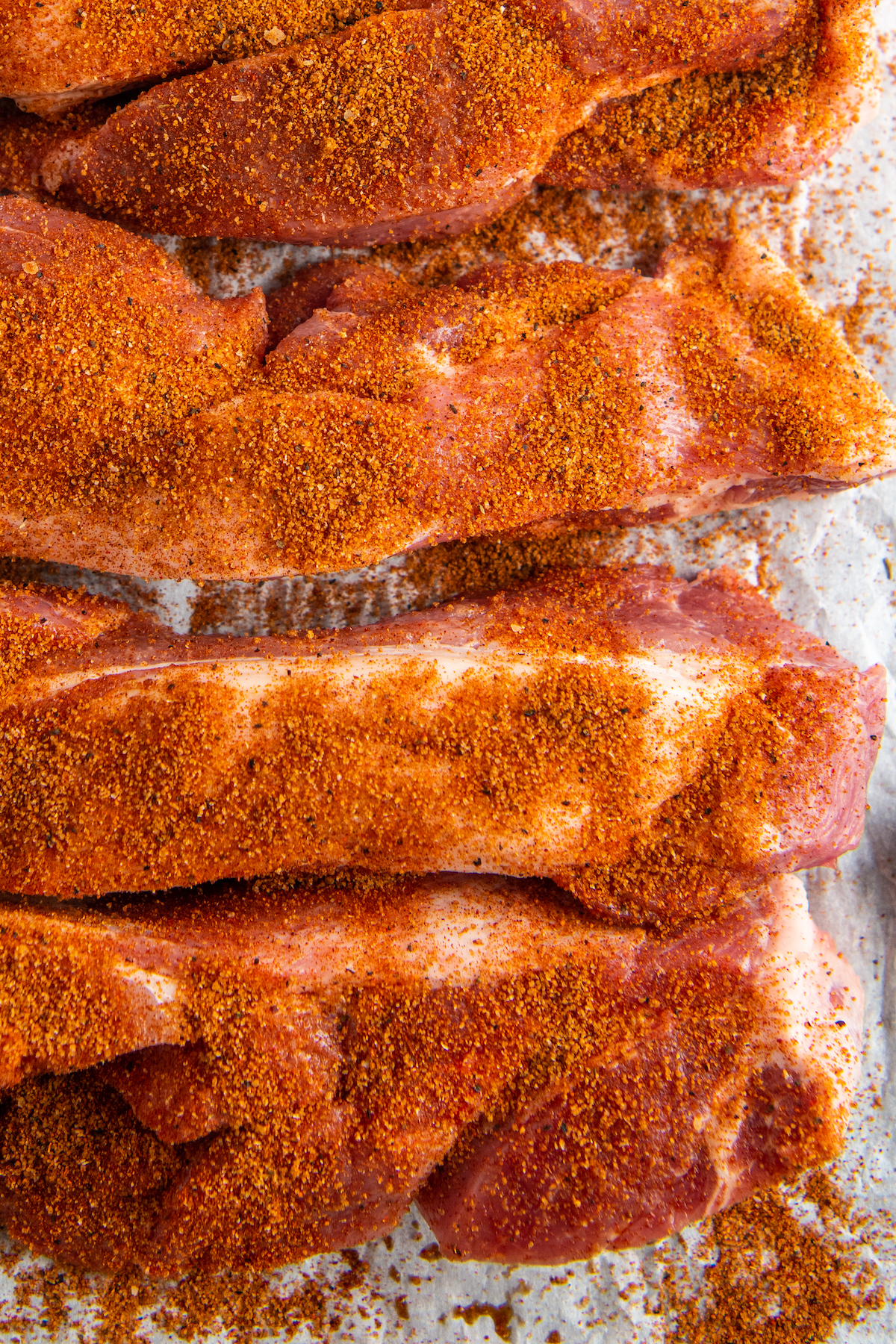 closeup of ribs covered in dry rub