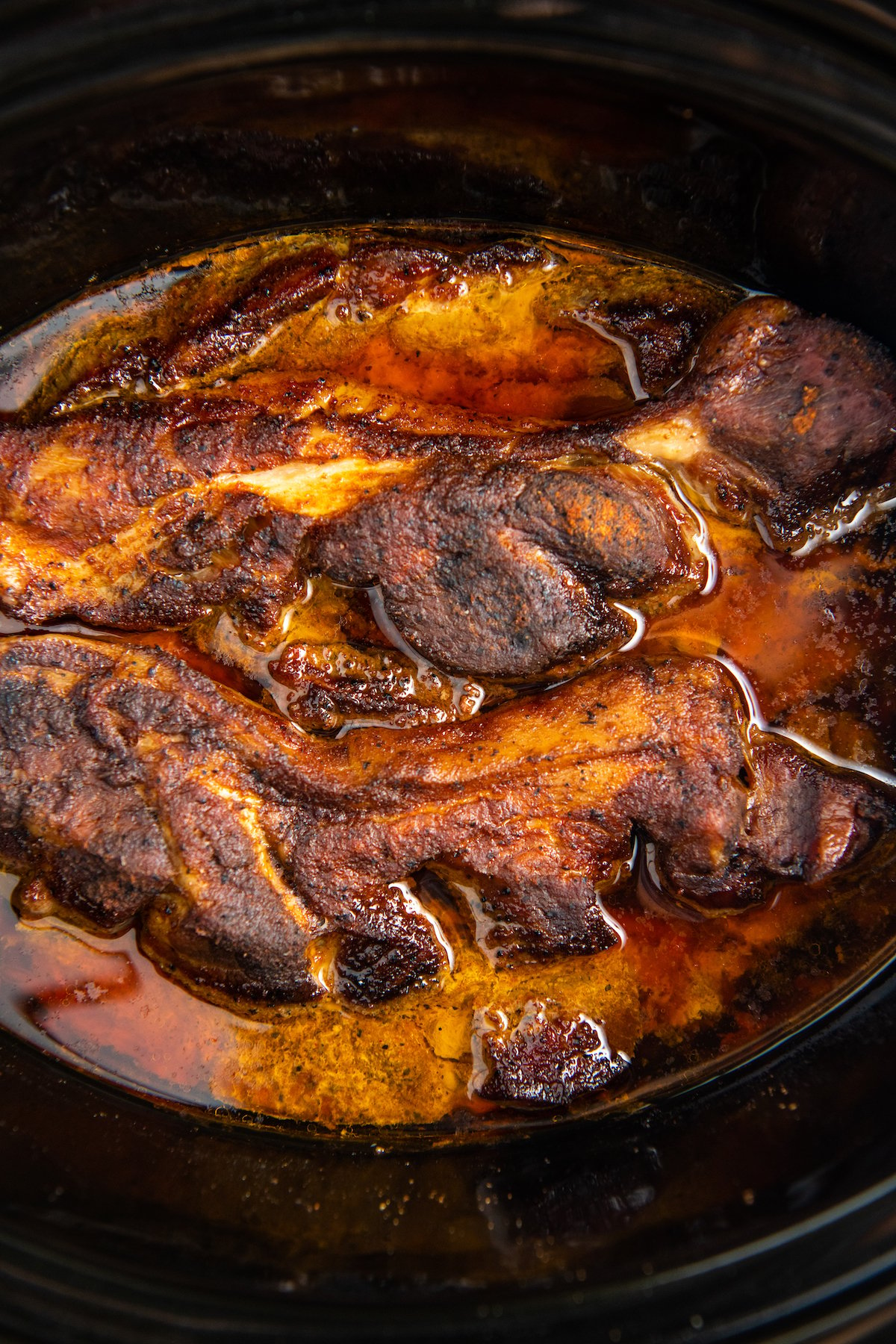 cooked ribs in black slow cooker