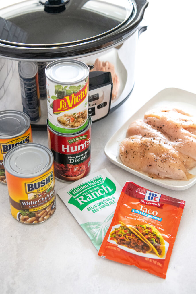 Ingredients for crockpot mexican white chicken chili arranged on top of a marble countertop.