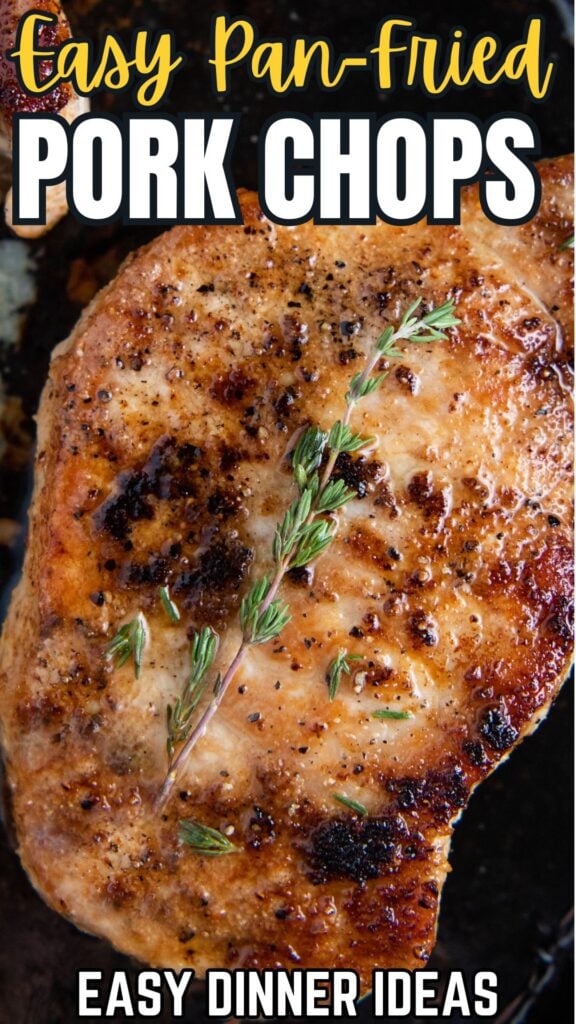 A pan fried pork chop is garnished with fresh thyme.