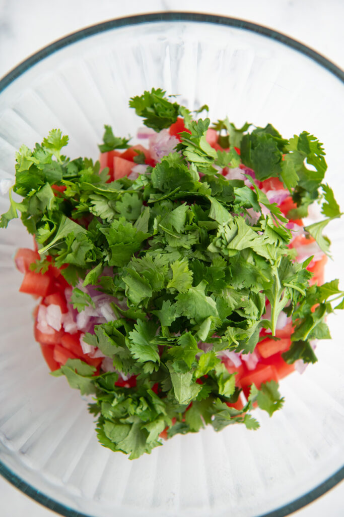 A bowl filled with cilantro.