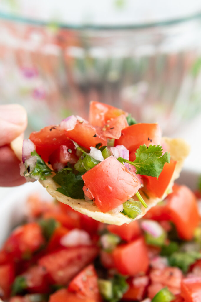 Fresh pico de Gallo on a tortilla chip.