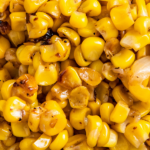 Overhead image of fried corn kernels in a bowl.