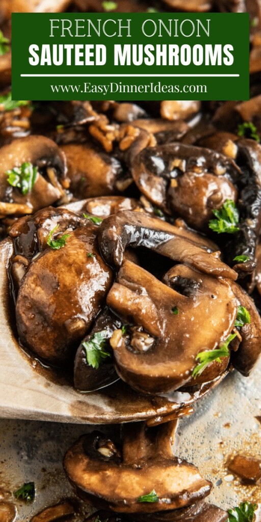 Sautéed mushrooms in a skillet with a wooden spoon scooping some up.