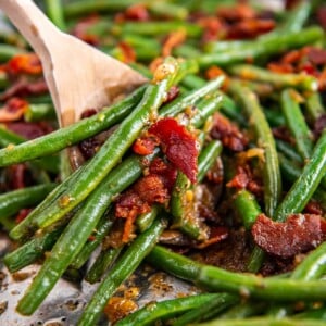 Green beans on a wooden spoon.