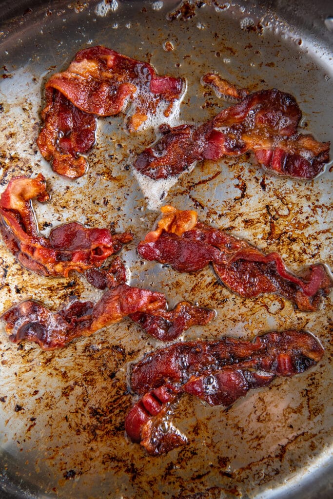 Crispy fried bacon in a skillet.