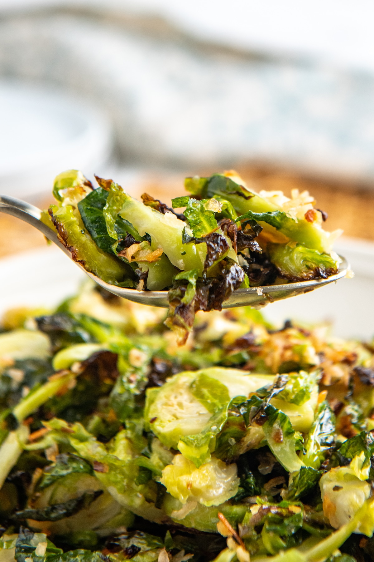 Up close image of cooked Brussels sprouts on a metal spoon.