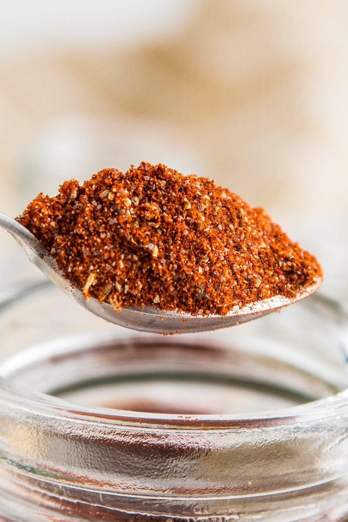 Cajun seasoning being scooped up with a spoon.