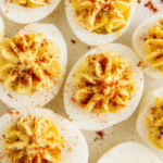 Nine deviled eggs on a white platter
