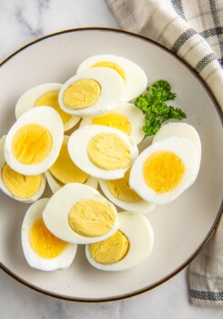 Sliced hard boiled eggs on a plate.